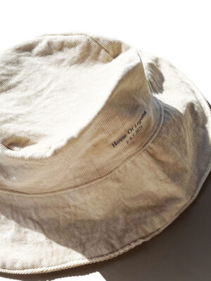 Light Brown Corduroy bucket hat featuring 'House Of Legerou' painting in gray.